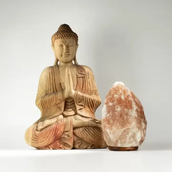 A Buddha statue and a salt lamp